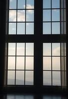 window with a view of the sky and clouds photo