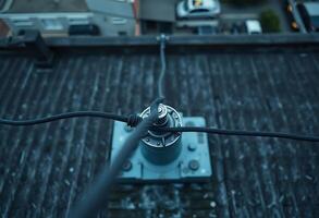 close up of a power line with a building in the background photo