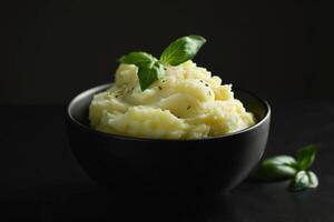 Warm comforting serving of mashed potatoes with crispy butter and fresh parsley photo