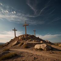 Three crosses on top of a hill with a blue sky photo