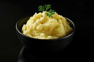 Rich and indulgent dish of creamy mashed potatoes with garlic butter and thyme photo