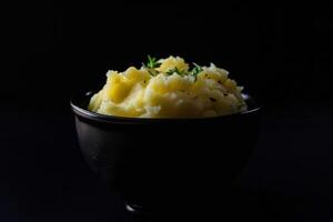 Indulgent treat of creamy mashed potatoes topped with garlic butter and fresh herbs photo