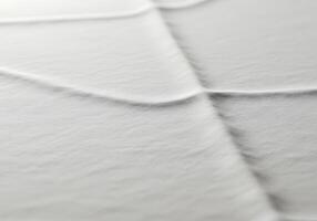 A close up of a white sheet with a wavy pattern photo