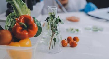 A person in a lab coat is holding a glass of water and a container with vegetables photo
