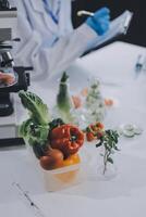 A scientist is working on a project with vegetables photo