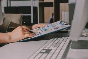 A person is using a clipboard to write on a computer photo