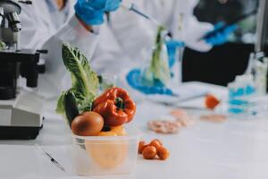 Scientists in lab coats working with vegetables photo