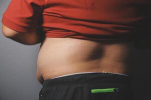 A man with a belly and a red shirt photo