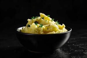 Soft fluffy bowl of creamy mashed potatoes topped with melted butter and fragrant herbs photo
