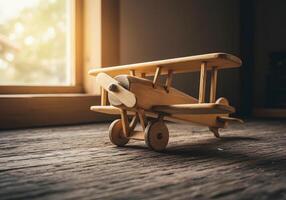 Wooden toy airplane on textured surface near window with natural light photo