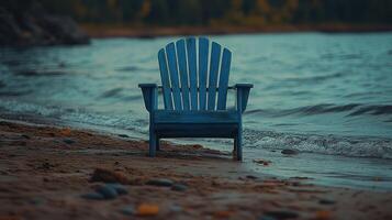 A blue chair sitting on the beach photo