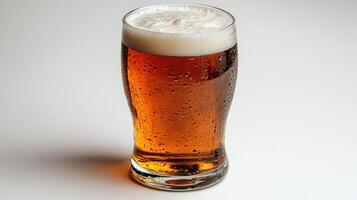A glass of beer on a white surface photo
