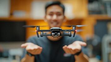 A man holding a small black drone in his hands photo