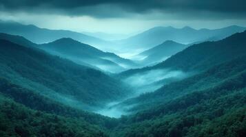 A view of the mountains with fog and trees photo