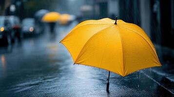 A yellow umbrella in the rain photo