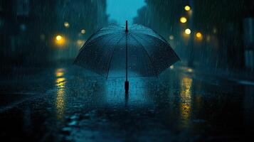 A wet street at night with a wet umbrella photo