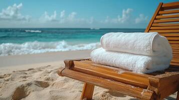 Two towels on a wooden chair on the beach photo