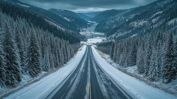 A snowy road in the mountains with trees and snow photo