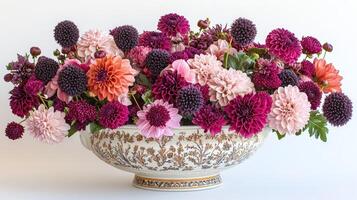 A large bowl filled with purple and pink flowers photo