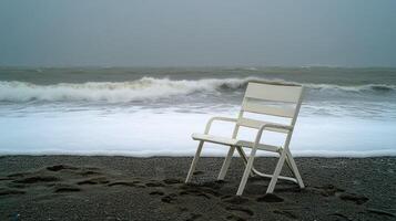 A chair sitting on a beach with waves crashing in the background photo