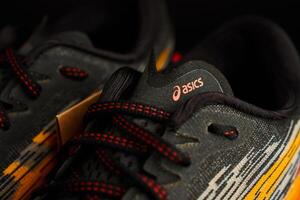 Wroclaw, Poland, 2024 - Close-up of ASICS running shoe with red laces and knit upper photo