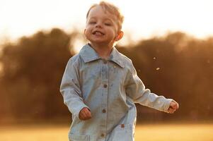 Having fun, running. Little boy i,,s on the summer field photo