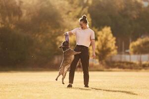 Woman ,is with dog on ,the summer field photo