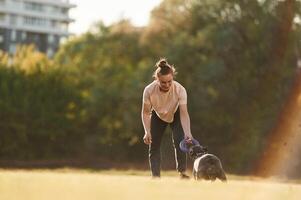 Woman is with dog on ,the summer field photo