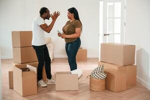 Arguing,, having a quarrel... African, American couple are moving into new house photo
