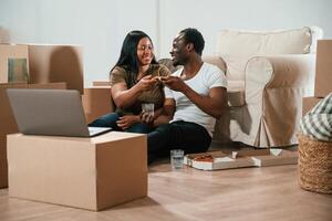 Conception ,of, celebration, eating pizza. African American couple are moving into new house photo