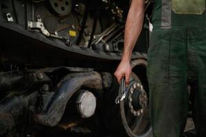 Holding wrench. Mechanic's, hand ,fixing machinery in workshop photo
