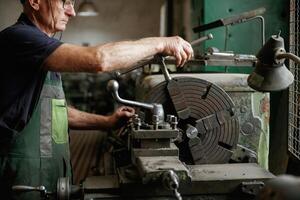 Focused view. ..Close-up of worker's, hands operating industrial machinery in workshop photo