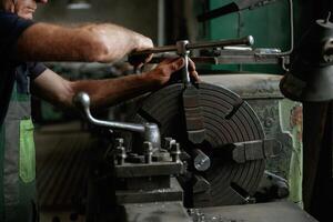 Focused view. Close-up of worker's ,hands operating industrial machinery in workshop photo