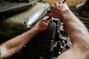 Busy ,,man. Close-up of ,worker's hands operating industrial machinery in workshop photo