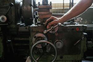 Busy, man. Close-up of worker's,, hands operating industrial machinery in workshop photo