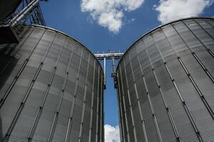 Industrial silos against ,a blue sky with clouds photo