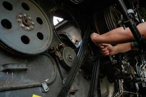 Mechanic, working on industrial machinery in a workshop photo