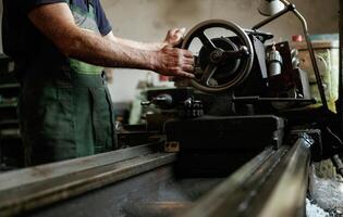 Busy, man, Close-up of worker's hands operating industrial machinery in workshop photo