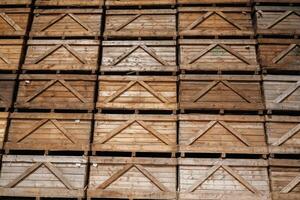Stacked, wooden crates in an organized warehouse setting photo