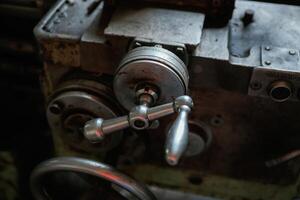 Close-up of old mechanical machinery with metal handles photo