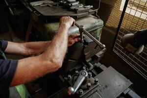 Focused ,view. Close-up of worker's hands operating industrial machinery in workshop photo