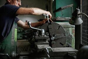 Focused view,. Close-up of worker's hands operating industrial machinery in workshop photo