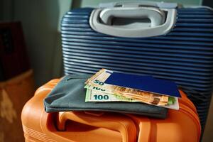 Passport and cash money on suitcase. Preparation for trip photo