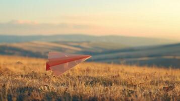 A paper airplane is flying in the middle of a field photo