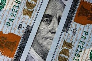 Benjamin Franklin's eyes from a hundred-dollar bill. The eyes of Benjamin Franklin on the hundred dollar banknote, backgrounds, close-up. 100 dollar bill with only eyes of Benjamin Franklin photo
