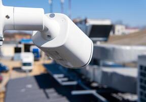 CCTV surveillance camera in factory area to control security system area with torch light and copy space. photo