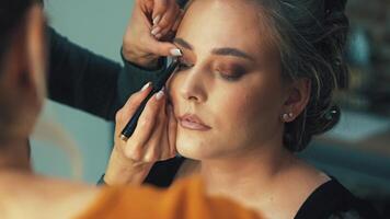 Soft brush strokes on the face create a fresh and natural makeup effect. Final touches add sophistication and completeness to the look of the Slavic girl video