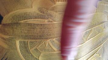 Hand painting abstract gold brushstrokes on canvas with dynamic movements and texture transformation in high resolution. video