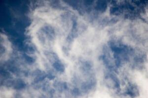 A plane flying through the sky with a cloud in the background photo
