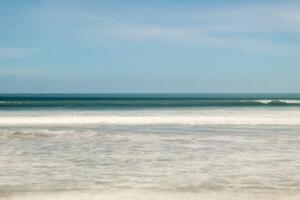 A surfer is riding a wave on the beach photo